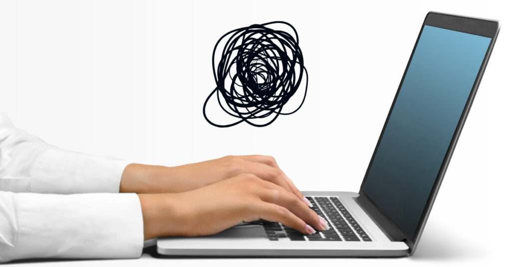 Hands typing on a laptop with a scribble above the screen, representing the start of the deck writing process.