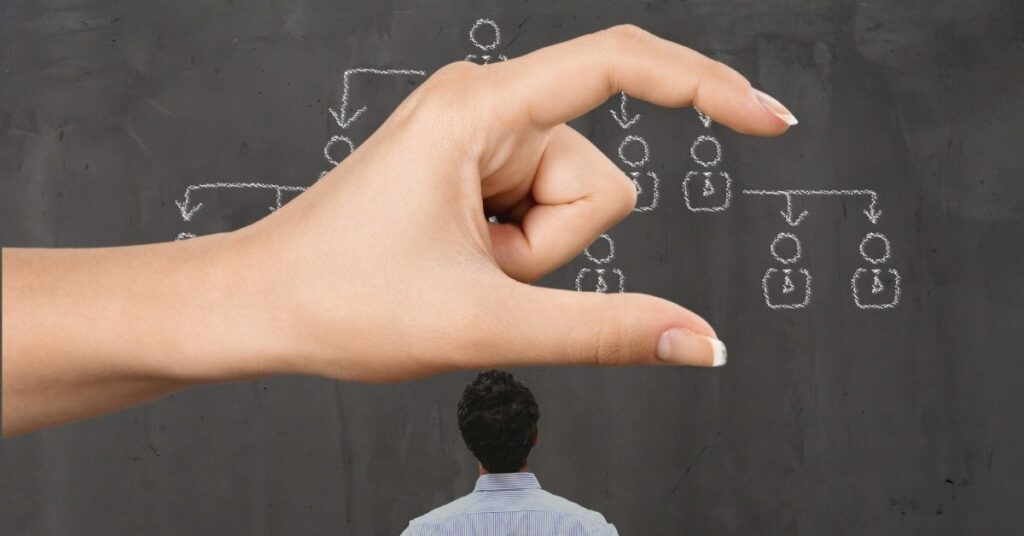 Hand arranging icons on a chalkboard, visualizing unstructured data organization