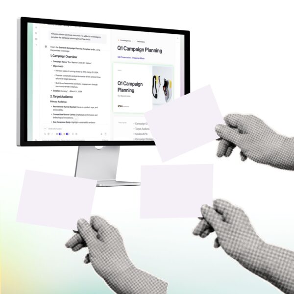 Hands holding up blank cards in front of a computer screen displaying a campaign planning presentation, symbolizing how AI marketing tools like Aurora Slides turn unstructured data into client-ready decks.